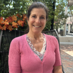 Dr. Nancy Palermo wearing soft pink tones symbolizing breast cancer awareness and holistic health.