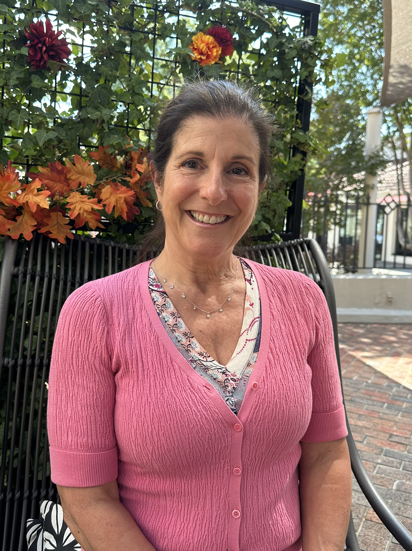 Dr. Nancy Palermo wearing soft pink tones symbolizing breast cancer awareness and holistic health.