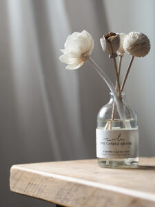 Organic flower diffuser with seeds on a wooden tray