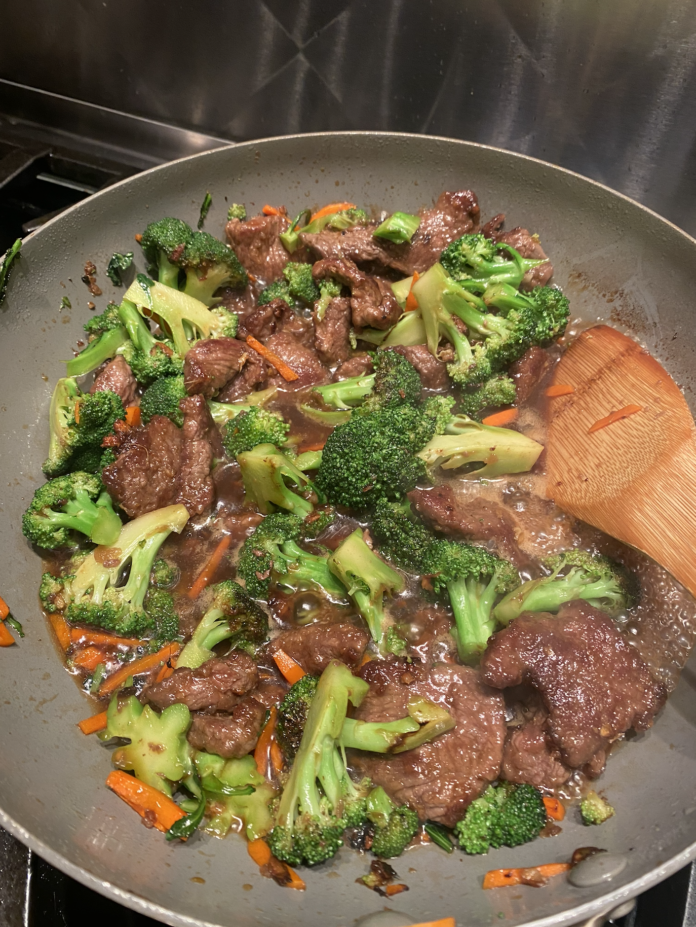 Homemade beef and broccoli stir fry in a skillet with glossy sauce.