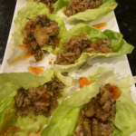 Chicken lettuce wraps with ground chicken, water chestnuts, and peanuts in butter lettuce cups.