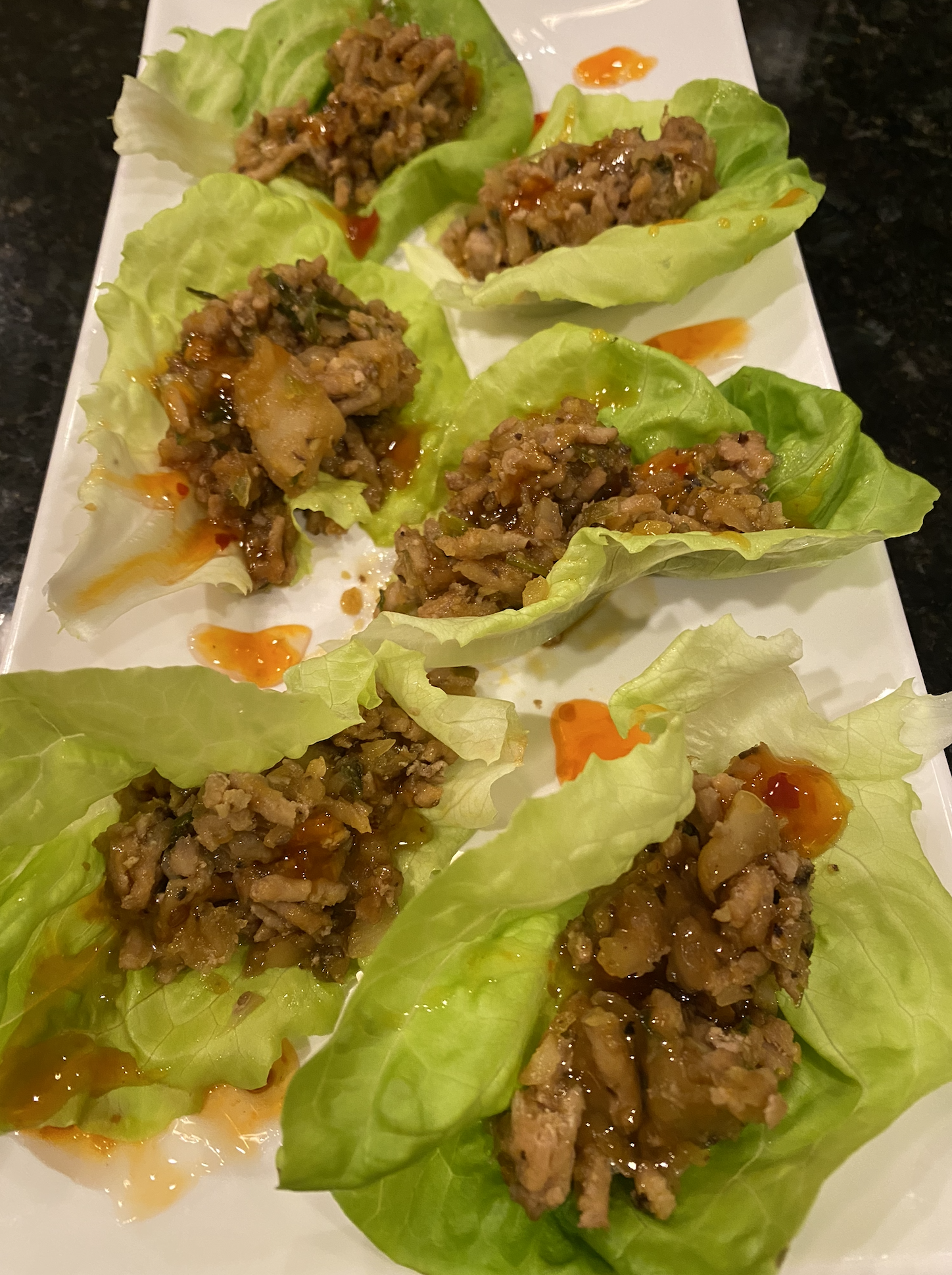 Chicken lettuce wraps with ground chicken, water chestnuts, and peanuts in butter lettuce cups.