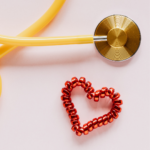 Heart health concept with stethoscope, fresh vegetables, and lifestyle symbols representing prevention and cardiovascular wellness.