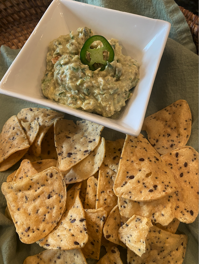 Guacamole with toasted cumin, lime, cilantro, and fresh avocado in a bowl