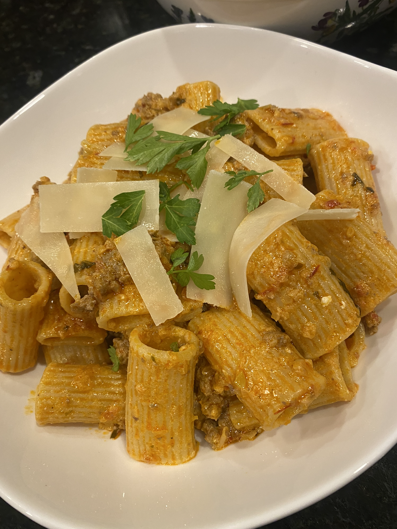 Mediterranean bolognese with lamb, harissa, mushrooms, and goat cheese served over pasta