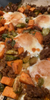 Sheet-pan breakfast with baked eggs, sweet potatoes, Brussels sprouts, shallots, and chorizo