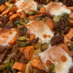 Sheet-pan breakfast with baked eggs, sweet potatoes, Brussels sprouts, shallots, and chorizo